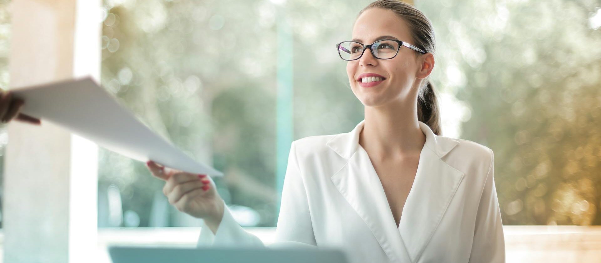 Mujer entrega un trámite, sonriente, hecho con un modelo de autorización